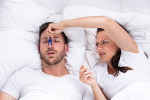 man snoring in bed with sleep apnea